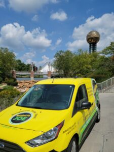 Yellow Mosquito Joe van parked next Iconic Knoxville, TN Landmark