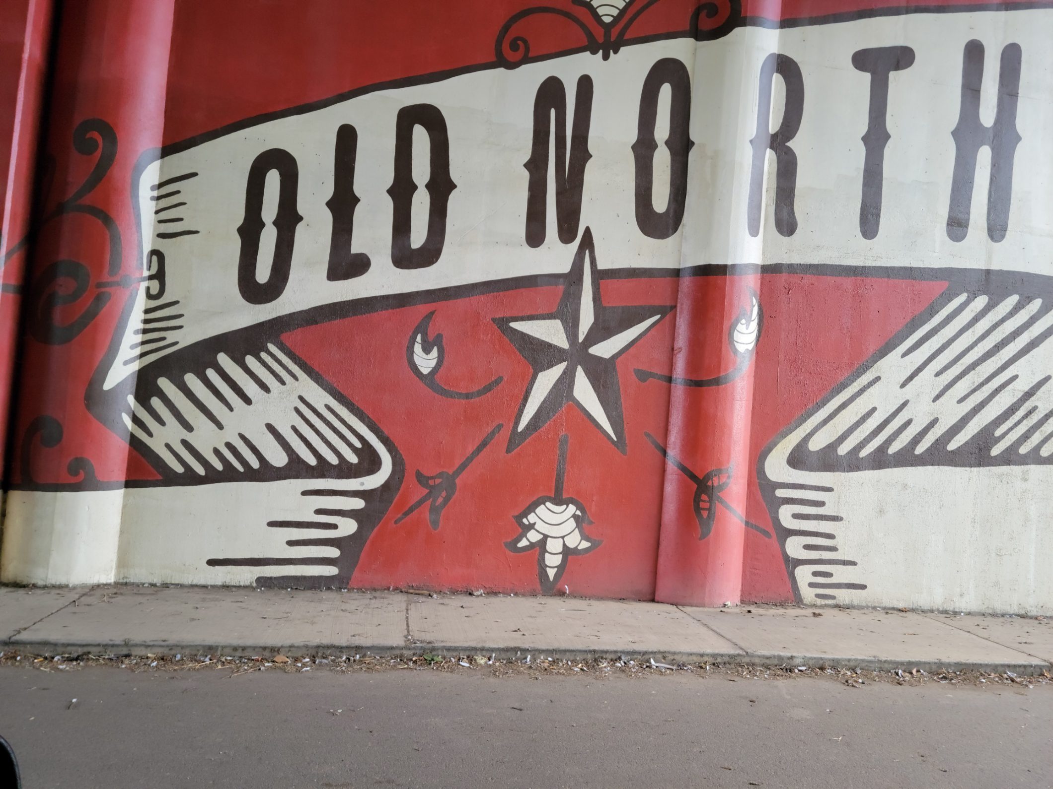 Red and white wall with a Old North banner and a star