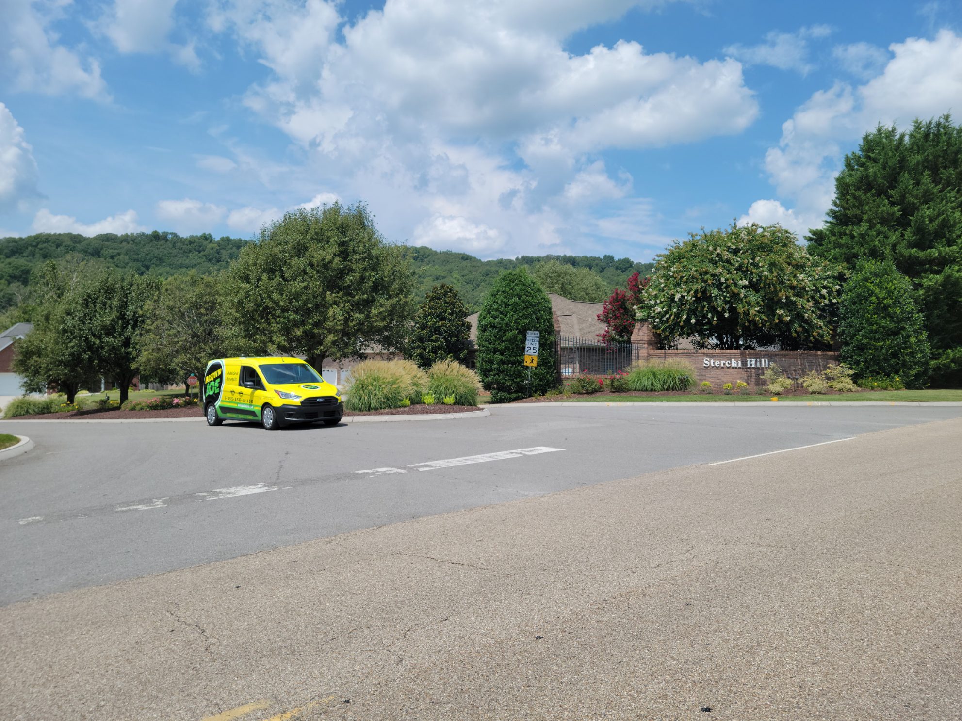 Yellow service van driving through Stretch Hill Community